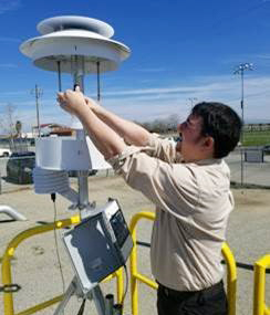 Man working with air monitoring machinery