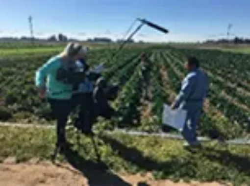 Photo of two people setting up monitoring equipment